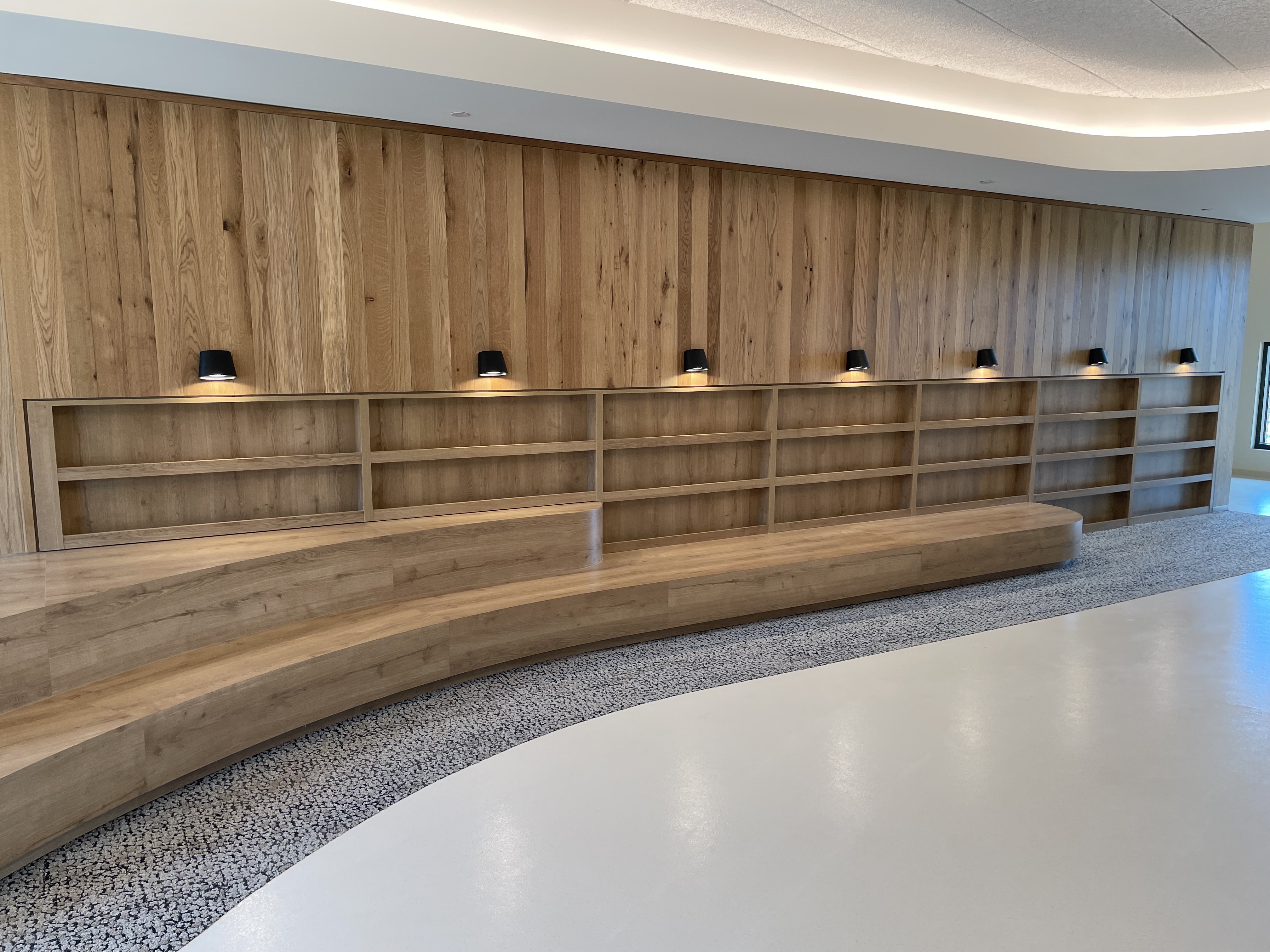 Bandwidth HQ — curved built-in bookshelf wall by MDN Cabinets, Raleigh NC