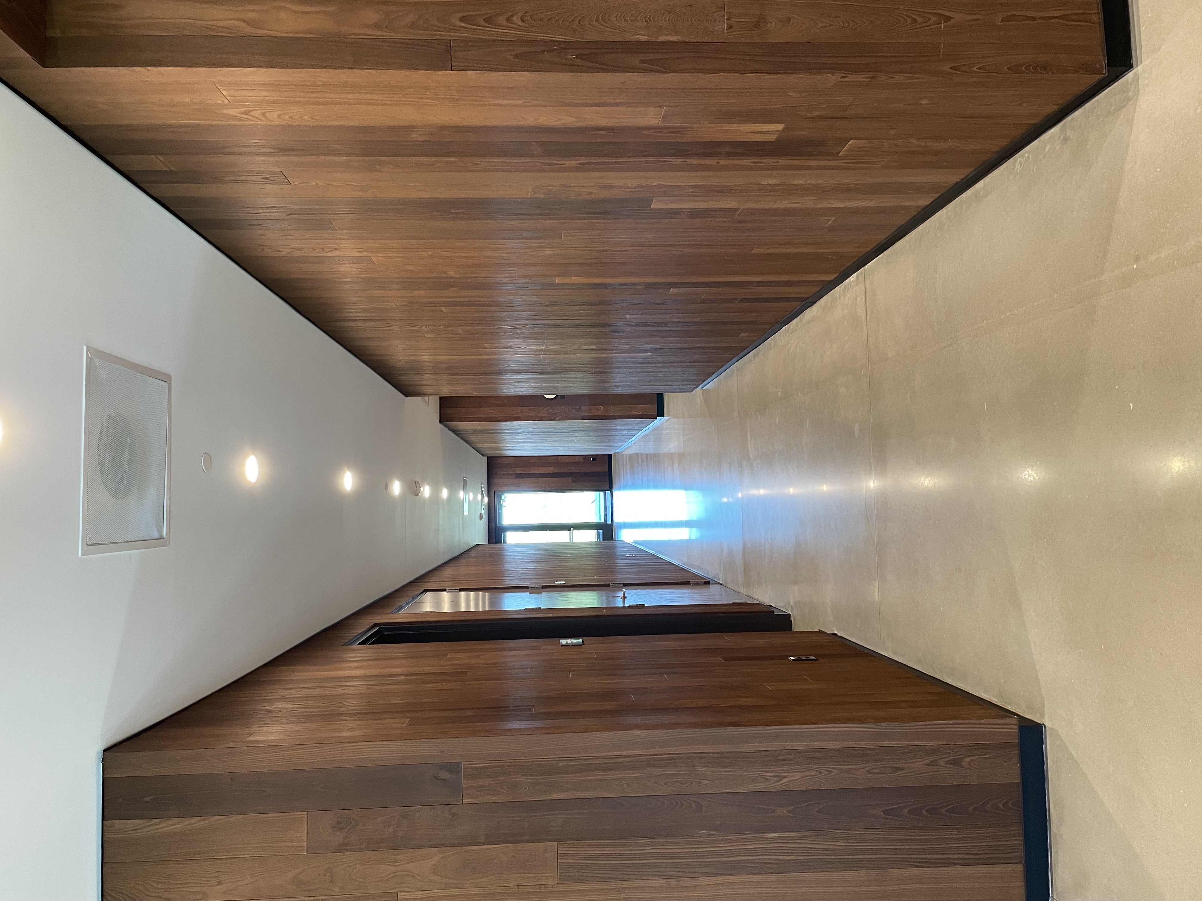 Bandwidth HQ — hallway with wall-to-wall walnut paneling