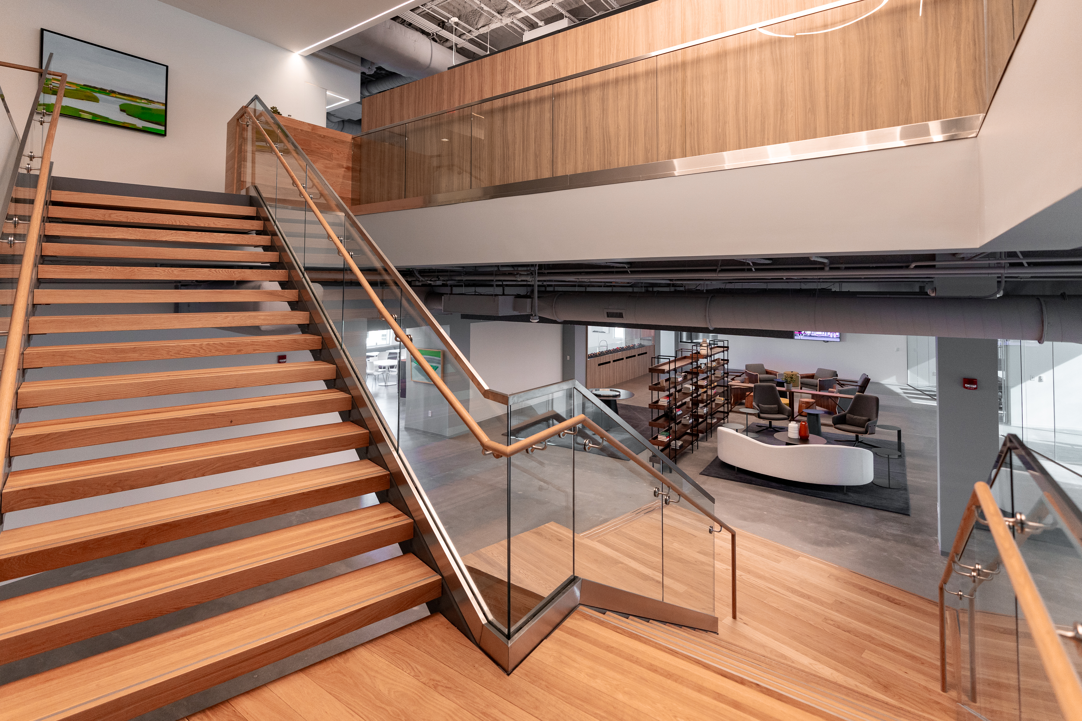 TrueBridge Capital — grand staircase with wood treads and paneling