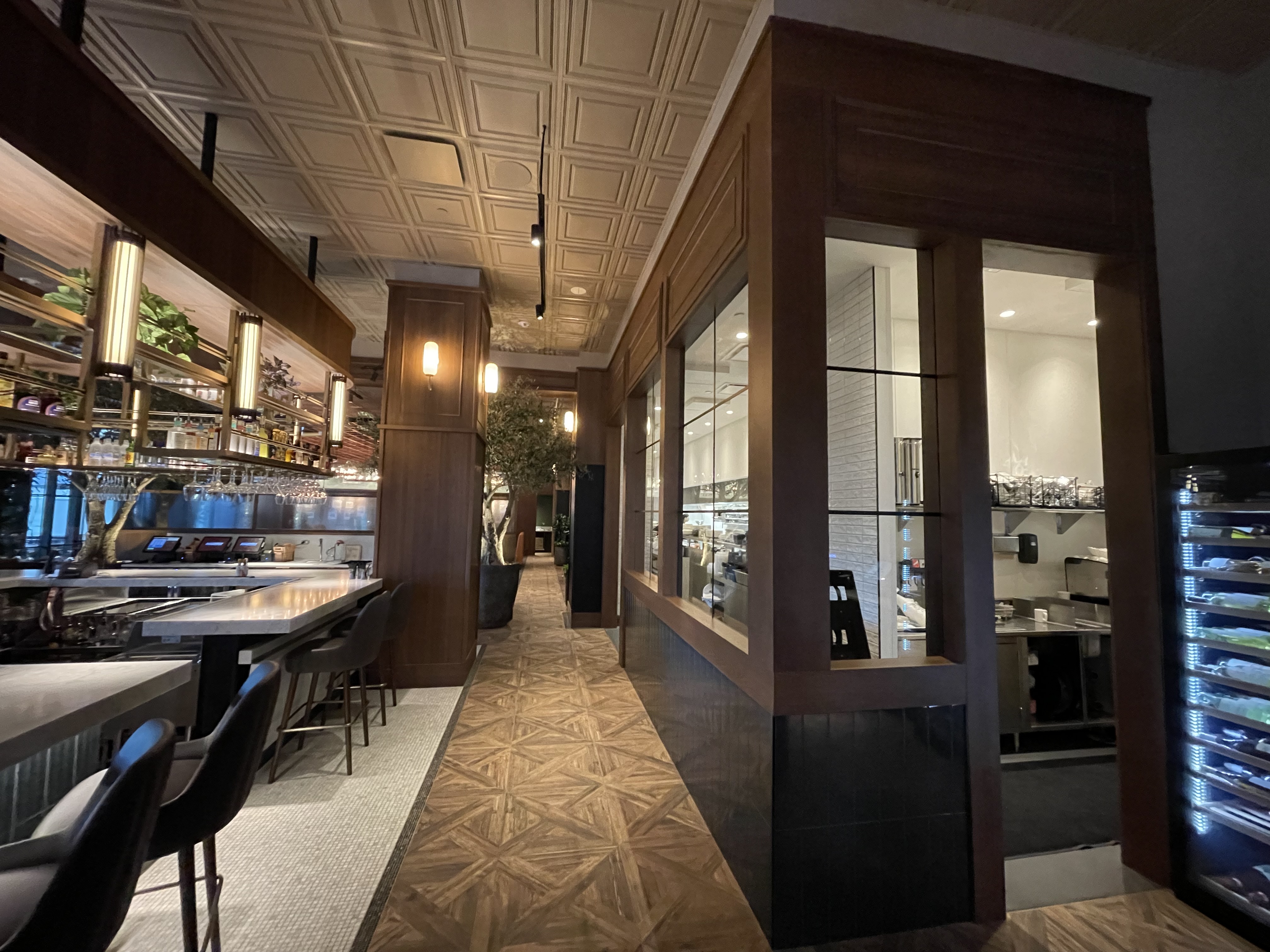 Village Tavern — hallway with custom wood paneling and cabinetry